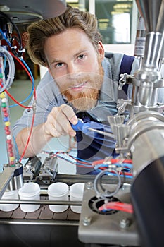 modern industrial machine operator working on machine