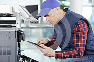 modern industrial machine operator working on machine