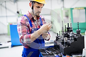 Modern industrial machine operator working in factory