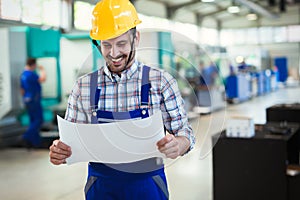 Modern industrial machine operator working in factory