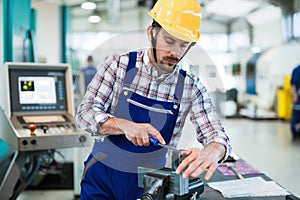 Modern industrial machine operator working in factory