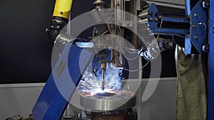 Modern Industrial Robot welding machine active in factory. Automation welding mechanical procedure. High Precision