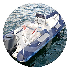 Modern inflatable boat with engine in the sea near shore