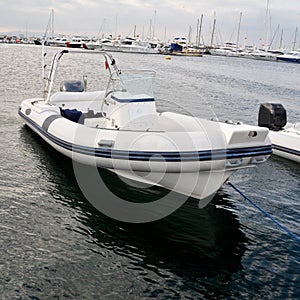 Modern inflatable boat with engine in the sea near shore