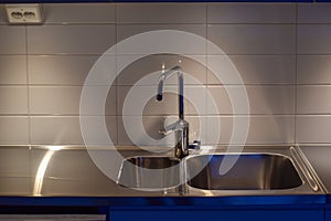 Modern interior of apartment. Luxury grey kitchen set. Huge sink.