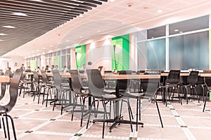 Modern interior of cafeteria or canteen with chairs and tables