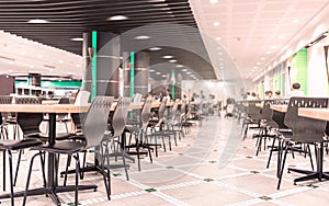 Modern interior of cafeteria or canteen with chairs and tables