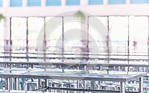 Modern interior of cafeteria or canteen with stainless steel chairs and tables