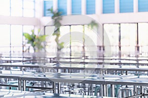 Modern interior of cafeteria or canteen with stainless steel chairs and tables