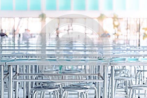 Modern interior of cafeteria or canteen with stainless steel chairs and tables