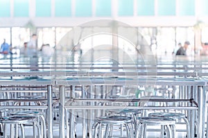 Modern interior of cafeteria or canteen with stainless steel chairs and tables