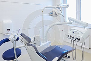 An interior of a dental office with white and blue furniture. DentistÃ¢â¬â¢s office photo