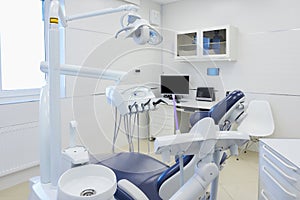 An interior of a dental office with white and blue furniture. DentistÃ¢â¬â¢s office photo