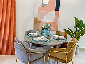 Modern interior design- furnished round dining table with four chairs