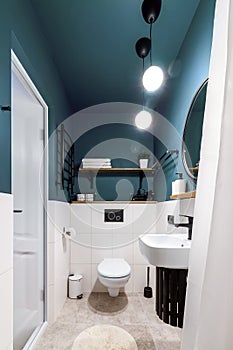 Modern interior design of a small bathroom. Blue style. Black plumbing