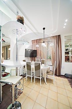 Modern interior of a dining room with an table and a TV