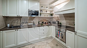 Modern interior of light kitchen in luxury apartment. Home appliances. Sink.