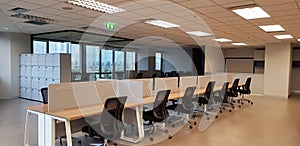 Modern interior office design with row black chairs and wooden table with window and building view background in black and white t