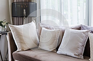 Modern interior pillows on brown sofa