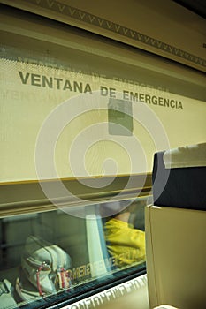 Modern interior of a Spanish passenger train AVE. Emergency window photo