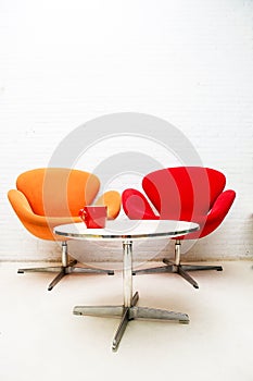 Modern interior table with coffee cup and two chairs