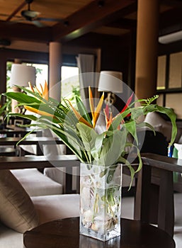 Modern interior in a Thai style with bouquet of flowers