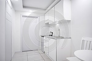 Modern interior white kitchen room with built-in furniture mockup showcase for boutique hotel room