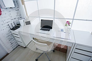 Modern interior workplace with laptop in white colors