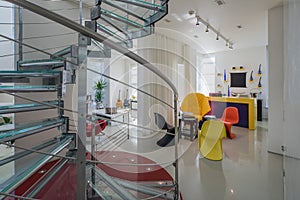 Modern interiro of luxury private house. Glass metal spiral staircase.