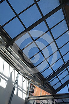 Modern internal structure of glass roof construction with lockable windows sections, inside view of modern glass roof