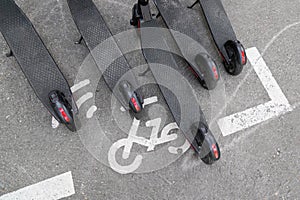 Modern Ñity transport electric e scooters parked on street city