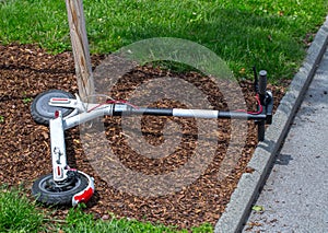 Modern Ñity transport - electric scooters is lying on the lawn.