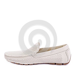 Modern ivory perforated leather men\'s moccasin shoe isolated on a white background with copy space.