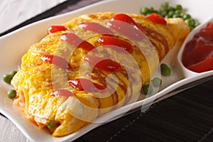 Modern Japanese food: Omurice close-up on a plate. horizontal