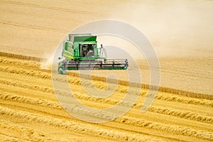 Modern John Deere combine harvester cutting crops