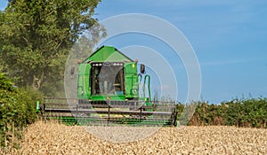 Modern John Deere combine harvester cutting crops