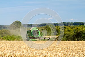 Modern John Deere combine harvester cutting crops