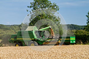 Modern John Deere combine harvester cutting crops