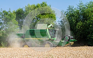 Modern John Deere combine harvester cutting crops