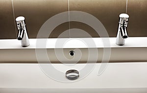 Modern kerrock sink with two shining tap faucets