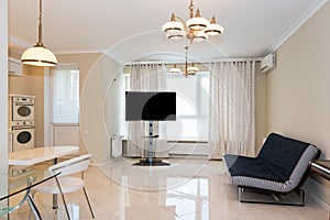 Modern kitchen area attached to the living room. Interior design with classic or vintage and modern elements.