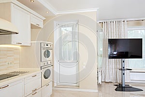 Modern kitchen area attached to the living room. Interior design with classic or vintage and modern elements.