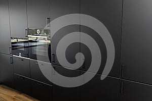 Modern kitchen with black fronts, built in oven and microwave, vinyl panels on the floor.