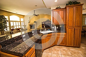 Modern Kitchen With Black Granite Counter Top & Rich Wood Cabinets