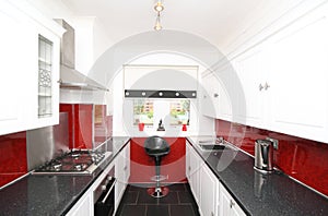 Modern kitchen with black, white and red panels