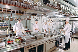 Modern kitchen. The chefs prepare meals in the restaurant`s kitchen