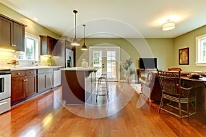 Modern kitchen with cherry floor and living room..