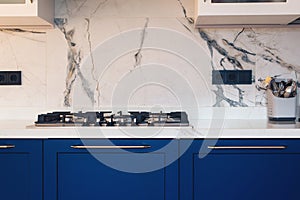 Modern kitchen clean interior design. Modern luxury gas stove top with tiled backsplash