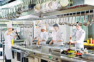 Modern kitchen. Cooks prepare meals on the stove in the kitchen of the restaurant or hotel. The fire in the kitchen.