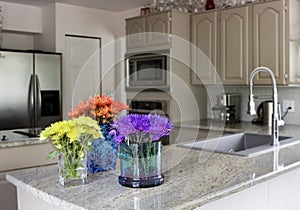 Modern kitchen with flowers on counter